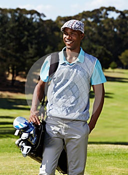 Perfect day for a round of golf. a young golf pro ready for a day on the course.