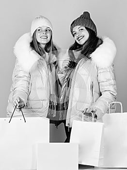 Perfect day. winter holidays. women in down jacket. girls shopping bags. christmas shopping sales. fun and gifts