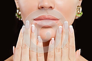 Perfect female hands with manicured nails and lips. French manicure and beige lipstick makeup