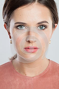 Perfect female model face with natural clear skin without retouch. Young brunette woman without retouching, closeup studio