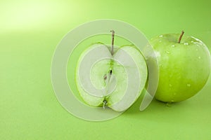 Perfect Fresh Green Apple Isolated on green Background with water drop in Full Depth of Field