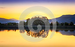 Perfect golden hour sunset over calm, reflective lake