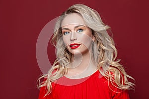 Perfect gorgeous fashion model woman with blonde curly hairdo and red lips makeup