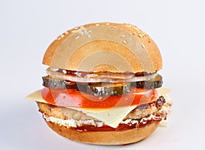 The perfect hamburger with cheese, bacon, pickles, tomato, onions and lettuce