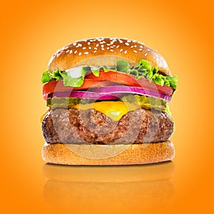 Perfect hamburger classic burger american cheeseburger isolated on colorful orange background