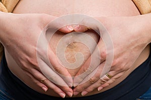 Perfect heart shape on pregnant woman belly