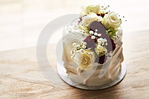 Perfect for life's sweetest moments. Still life shot of a beautiful wedding cake on top of a wooden surface.