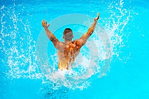 Perfect male Torso on blue water background. Vacation at Paradise. Vacation. Luxury Travel Expert. Young man Swimming