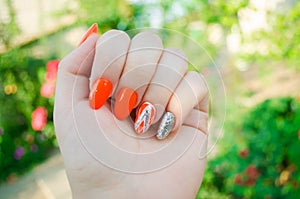 Perfect manicure and natural nails. Attractive modern nail art design. orange autumn design. long well-groomed nails