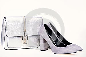 Perfect match concept. Shoes made out of grey suede on white background. Pair of fashionable high heeled shoes and