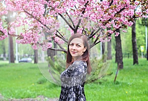 Perfect model with creative vivid makeup and pink lipstick on lips and traditional japanese hairstyle posing outside. Outdoor