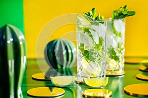 perfect mojito cocktails on vintage yellow background and hard shadows. Gin tonic