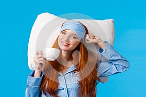 Perfect morning of princess. Cheerful, tender redhead woman with long ginger hair, wearing sleep mask and pyjama