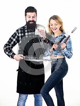 Perfect for ourdoor picnic. Bearded man and cute girl holding cooking grate with handle. Happy couple having grill grate