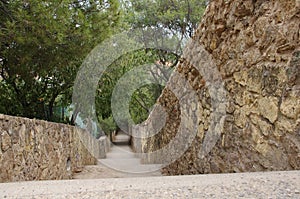 Perfect outdoor wall with stairs down a hill amoung a green area with park