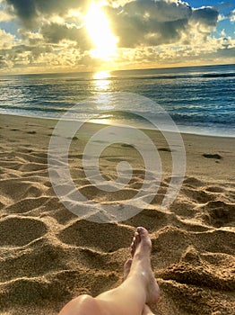 Perfect Paradise Feet up relaxing watching a glorious golden sunrise over the beach in Kauai Hawaii