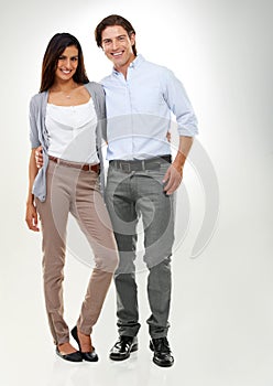 Perfect partners. Portrait of a multi-ethnic couple standing isolated on a white background.