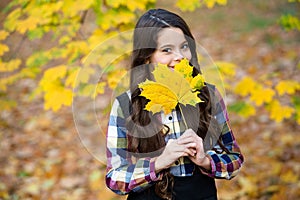 Perfect place to stay. small girl in autumn leaves. fall time. child with long hair in fall forest. beauty of nature