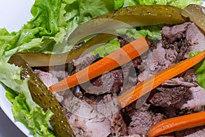 a perfect pork steak with pickled carrots and pickled cucumbers