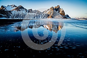 Perfect reflection of the peaks of Vestrahorn. Stokksnes, Iceland