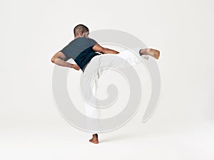 The perfect roundhouse. Studio shot of a young martial artist practicing.