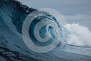 Perfect sea waves with blue water cloudy sky