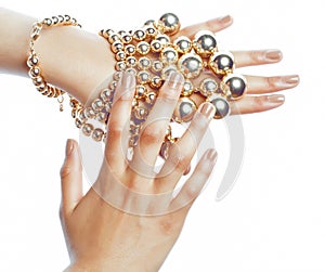 Perfect shape concept: african american woman hands with lot golden jewelry, stylish modern manicure isolated