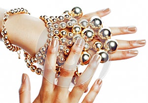 perfect shape concept: african american woman hands with lot golden jewelry, stylish modern manicure isolated
