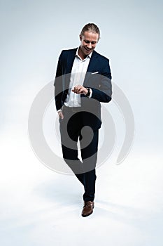 Perfect suit. Full length of handsome young man in suit looking at camera while standing against white background