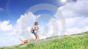 Perfect summer weather: young woman walks with her pet beagle in mountains