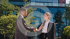 In a perfect sunny day charismatic black man and woman business workers meeting in front of modern business centre they