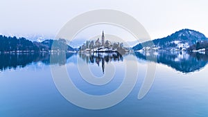 Perfect symetry of a lake and church on a small island, Bled, slovenian alps