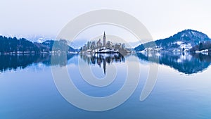 Perfect symetry of a lake and church on a small island, Bled, slovenian alps photo