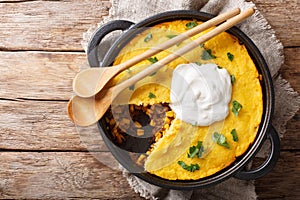 Perfect Tamale Pie Recipe - Rich zesty beef filling topped with fluffy corn bread closeup. horizontal top view