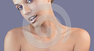 Perfect teeth smile with shiny lips. Beautiful close-up of a tanned face of a young woman with clean fresh skin.