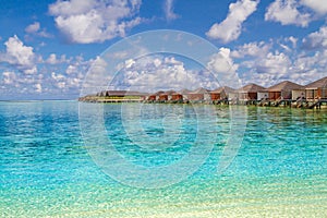 Perfect view of luxury water villas in Maldives island. Blue sea and blue sky, idyllic sea view from a wooden pier pathway