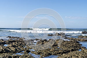 Perfect wave hover the rocks