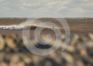 Perfect wave on a sunny day with foreground background bohkeh