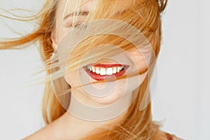 Perfect white smile of red-haired girl, close-up photo