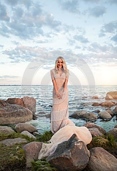 Perfect woman against summer sunset sky and clouds