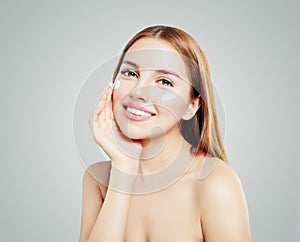 Perfect woman applying cream on her face. Skin care, beauty and facial treatment concept