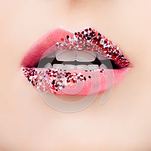 Perfect woman lips macro. Beautiful female mouth with glitter makeup and pink tint closeup