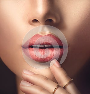 Perfect woman's sensual lips with beige matte lipstick photo