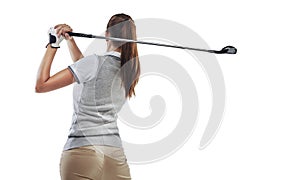 Perfecting her follow through. Studio shot of a young golfer practicing her swing isolated on white.