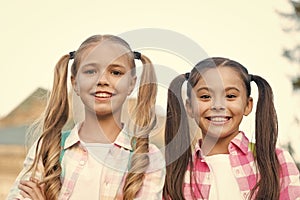 Perfection in beauty. Happy kids with long hair tails. Beauty look of small girls. Beauty shop. Hair salon. Fashion and