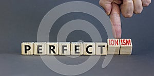 Perfectionism symbol. Concept words Perfect or Perfectionism beautiful wooden blocks. Beautiful grey table grey background.