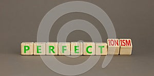 Perfectionism symbol. Concept words Perfect or Perfectionism beautiful wooden blocks. Beautiful grey table grey background.