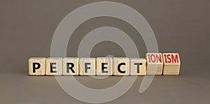 Perfectionism symbol. Concept words Perfect or Perfectionism beautiful wooden blocks. Beautiful grey table grey background.