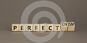 Perfectionism symbol. Concept words Perfect or Perfectionism beautiful wooden blocks. Beautiful grey table grey background.