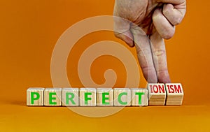 Perfectionism symbol. Concept words Perfect or Perfectionism beautiful wooden blocks. Beautiful orange background. Businessman